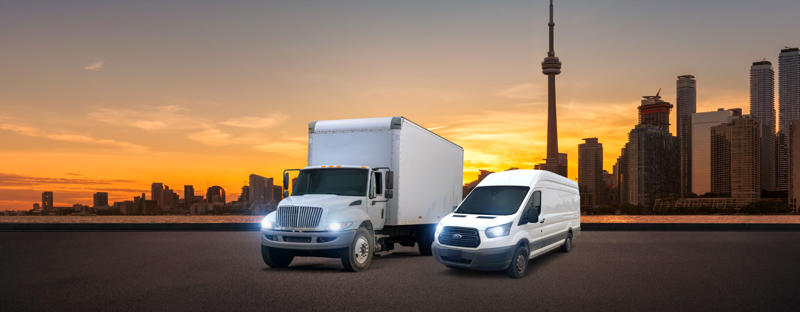 White city truck and courier van carrying expedited shipments parked in front of Toronto, ON cityscape
